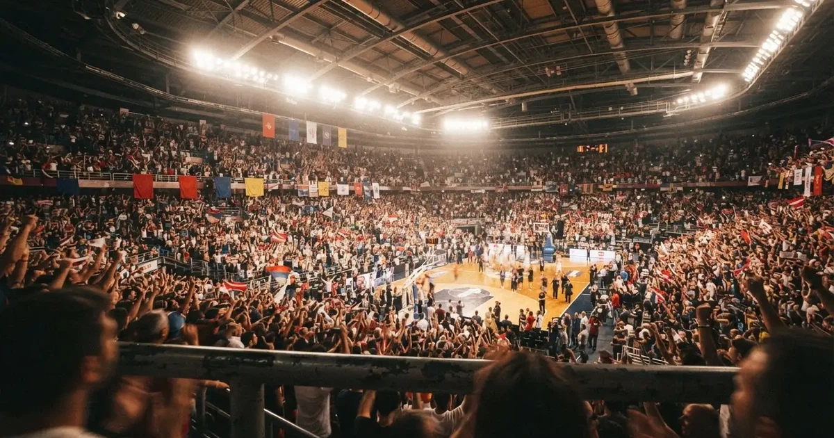 A packed sports hall under floodlights photographed from a long way off