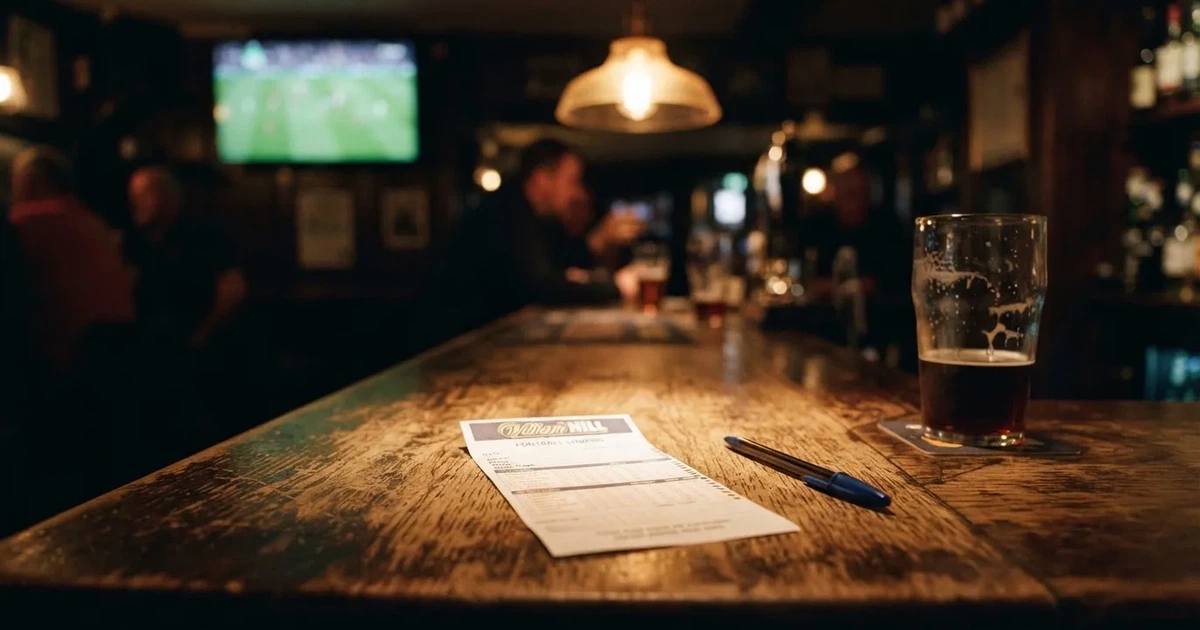A blank paper betting slip beside a pen on a wooden counter