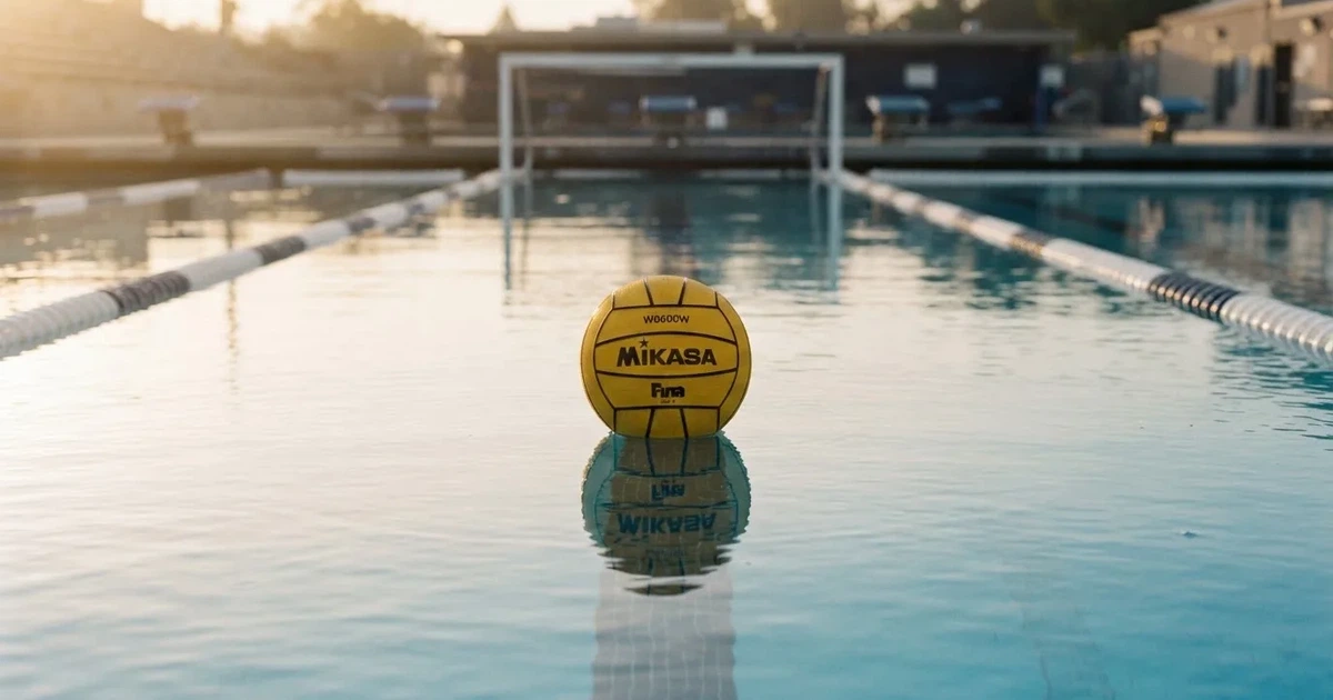 A ball on the centre spot of a grass pitch in morning light