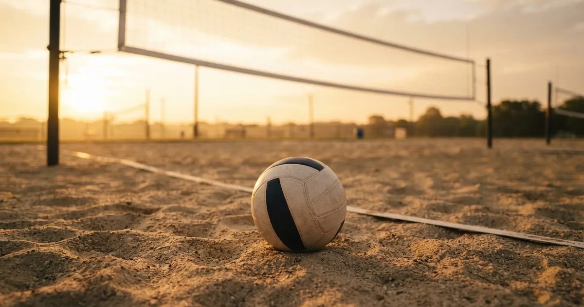 A ball on the centre spot of a grass pitch in morning light