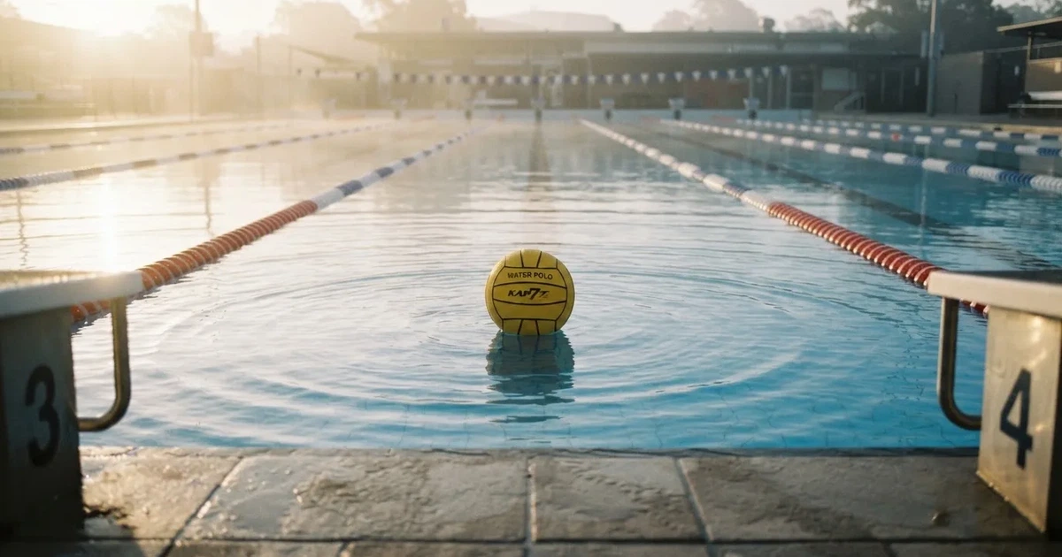 A ball on the centre spot of a grass pitch in morning light